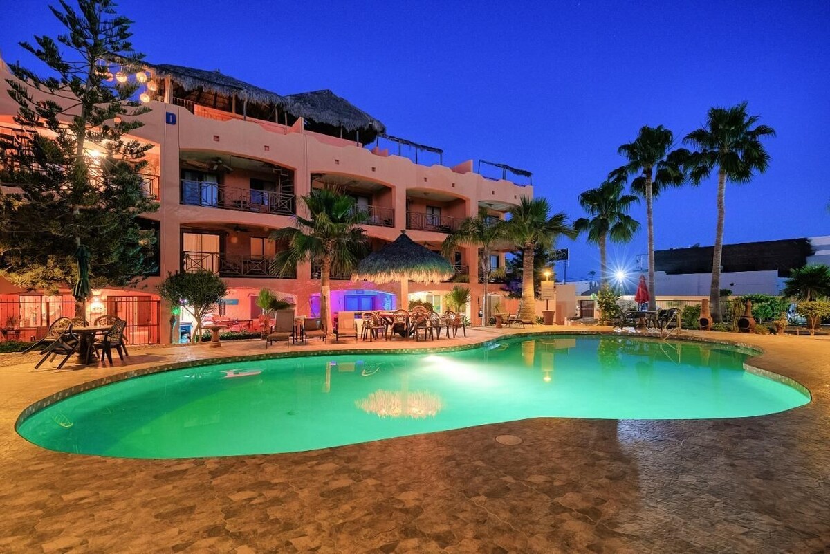 Illuminated pool and condominium building at night