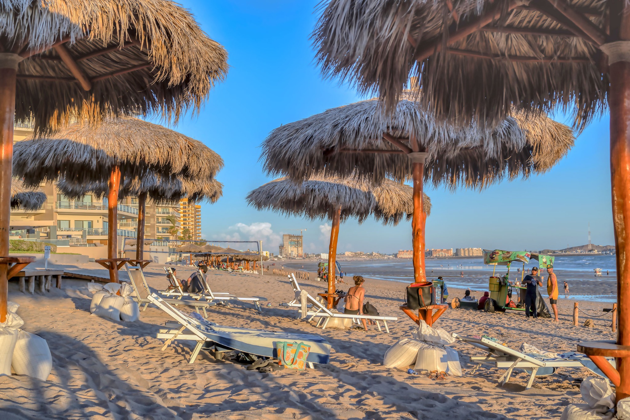 Beach palapas and lounge chairs