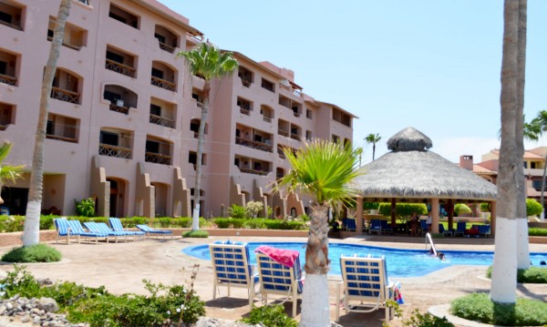 Poolside palapa and condominium building