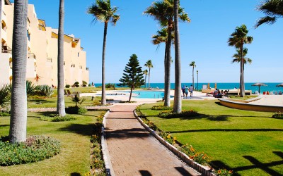Landscaped walkway with pool and ocean views